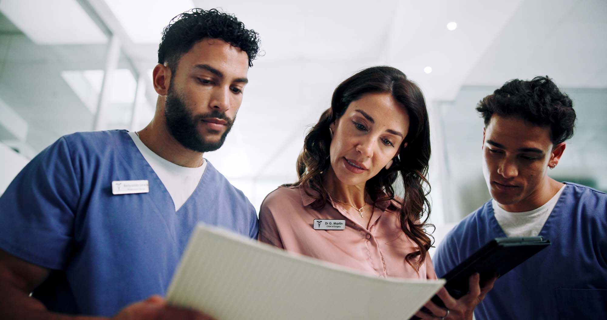 Hospital chief, documents and planning with doctors and woman for consultant, schedule and feedback.