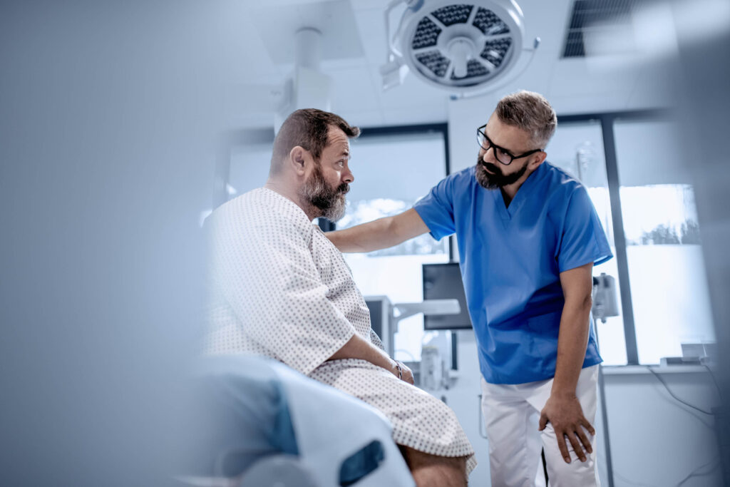 Supportive doctor soothing worried overweight patient, discussing test result in emergency room. Illnesses and diseases in middle-aged men's health. Compassionate physician supporting stressed patient. Concept of health risks of overwight and obesity.